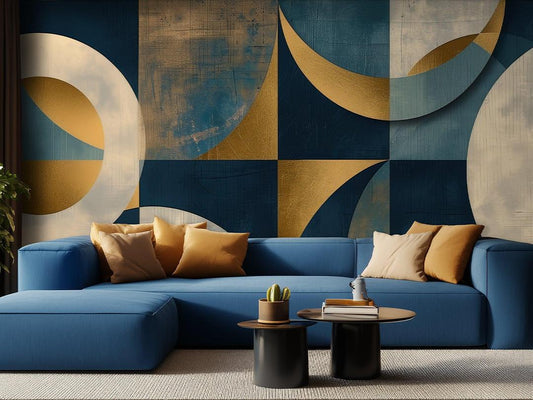 Modern living room with a blue sectional sofa and a retro geometric wallpaper in gold, blue, and white.